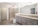 Modern bathroom featuring a glass-enclosed shower and dual vanities with granite countertops at 11679 Red Rust Ln, Charlotte, NC 28277
