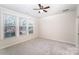 Bedroom featuring a ceiling fan, carpeted floor, and window providing natural light at 11679 Red Rust Ln, Charlotte, NC 28277