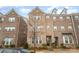Charming three-story brick townhome featuring a well-maintained facade and inviting entrance at 11679 Red Rust Ln, Charlotte, NC 28277