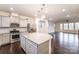 Modern kitchen with stainless steel appliances, gray cabinets, granite countertops, and hardwood floors at 11679 Red Rust Ln, Charlotte, NC 28277