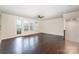 Spacious living room with hardwood floors, natural light, and a walk-out balcony at 11679 Red Rust Ln, Charlotte, NC 28277