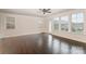 Inviting living room featuring hardwood floors, plenty of natural light, and a ceiling fan at 11679 Red Rust Ln, Charlotte, NC 28277