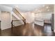 Open living space features hardwood floors, staircase, and kitchen with modern pendant lighting at 11679 Red Rust Ln, Charlotte, NC 28277