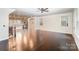 Open-concept living space with hardwood floors connecting the living room and kitchen at 11679 Red Rust Ln, Charlotte, NC 28277