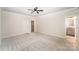 Spacious bedroom with a ceiling fan, carpeted floors, and access to ensuite bath and walk-in closet at 11679 Red Rust Ln, Charlotte, NC 28277