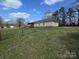 Large backyard with established lawn, mature trees, fencing, and access to a deck for outdoor living at 117 Jones Rd, Shelby, NC 28150