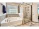 Primary bathroom featuring a soaking tub and walk-in shower at 120 Hornbeam Ln, Mooresville, NC 28117