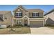 Charming two-story home with a welcoming front porch, a well-manicured lawn, and a two-car garage at 120 Hornbeam Ln, Mooresville, NC 28117