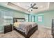 Spacious main bedroom featuring a ceiling fan, tray ceiling and large windows at 120 Hornbeam Ln, Mooresville, NC 28117