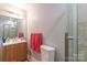 Bathroom with wood vanity, walk-in shower and soft, neutral paint colors at 1216 Center St, Wadesboro, NC 28170