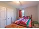 Bright bedroom with ceiling fan, natural light, and colorful quilt on the bed at 1216 Center St, Wadesboro, NC 28170
