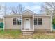 Charming single-story home featuring a covered front porch, neutral siding, and double-pane windows at 1216 Center St, Wadesboro, NC 28170