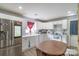 Well-lit kitchen featuring a stainless steel refrigerator, ample counter space, and white cabinetry at 1216 Center St, Wadesboro, NC 28170