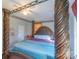 Bedroom featuring large bed, ornate wood frame, ceiling fan, and natural light at 1216 Center St, Wadesboro, NC 28170
