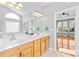 Bathroom with double vanity sinks and a view of the bedroom at 127 Oxford Dr, Mooresville, NC 28115