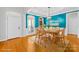 Staged dining room showcasing hardwood floors, large windows, and a table for six at 127 Oxford Dr, Mooresville, NC 28115
