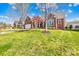 Charming brick home featuring a well-maintained lawn, a two-car garage, and mature trees at 127 Oxford Dr, Mooresville, NC 28115