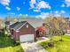 Aerial view of a beautiful brick home with a well-manicured lawn and a two-car garage at 127 Oxford Dr, Mooresville, NC 28115