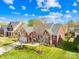 Aerial view of a well-maintained brick home with a two-car garage and mature trees in a lush lawn at 127 Oxford Dr, Mooresville, NC 28115