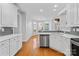 Bright kitchen featuring white cabinets, stainless steel appliances, and hardwood floors at 127 Oxford Dr, Mooresville, NC 28115