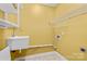 Bright laundry room features a sink, washer/dryer hookups, and overhead shelving at 127 Oxford Dr, Mooresville, NC 28115