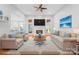 Staged living room with a fireplace, plush seating, and decor, creating a welcoming and comfortable space at 127 Oxford Dr, Mooresville, NC 28115