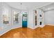 Cozy living room features hardwood floors, large windows, and a charming fireplace with a blue painted door at 127 Oxford Dr, Mooresville, NC 28115