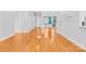 Well-lit living room with hardwood floors, showcasing an open layout and a glimpse into adjacent living spaces at 127 Oxford Dr, Mooresville, NC 28115