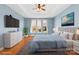 Staged bedroom with hardwood floors, tray ceiling, and large bed, creating a relaxing retreat at 127 Oxford Dr, Mooresville, NC 28115