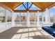 Sunroom featuring a wooden beamed ceiling, multiple windows, and a bed swing at 127 Oxford Dr, Mooresville, NC 28115