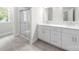Bright bathroom with white cabinets, dual sinks, and glass-enclosed shower at 1322 Condon St, Charlotte, NC 28216