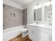 This bathroom features double sinks and tiled shower-tub combination at 1322 Condon St, Charlotte, NC 28216