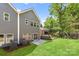 The rear exterior of the home with a concrete patio and a green lawn at 1322 Condon St, Charlotte, NC 28216
