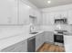 Bright kitchen with white cabinets, stainless steel appliances, and stylish tile backsplash at 1322 Condon St, Charlotte, NC 28216