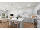 Bright, open-concept kitchen with a quartz island, stylish pendant lights, and stainless steel appliances at 1322 Condon St, Charlotte, NC 28216