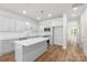 This kitchen includes an island, modern appliances, and white cabinets at 1322 Condon St, Charlotte, NC 28216
