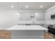 This modern kitchen features an island, quartz countertops, and white cabinets at 1322 Condon St, Charlotte, NC 28216