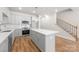 Modern kitchen with gray cabinets, stainless steel appliances, large island, and pendant lighting at 1322 Condon St, Charlotte, NC 28216