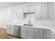 Well-lit kitchen with white cabinets, quartz countertops, and stainless steel appliances at 1322 Condon St, Charlotte, NC 28216