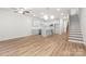 Open-concept living area featuring modern kitchen, hardwood floors, staircase, and natural lighting at 1322 Condon St, Charlotte, NC 28216
