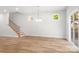 Open-concept living area featuring hardwood floors, staircase, and natural lighting at 1322 Condon St, Charlotte, NC 28216