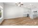 Open-concept living area featuring modern kitchen, hardwood floors and natural lighting at 1322 Condon St, Charlotte, NC 28216