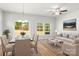 Bright living room with a dining area featuring a glass door and an open layout at 1322 Condon St, Charlotte, NC 28216