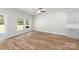 Bright room with hardwood floors, a ceiling fan, and access to the outdoors via a sliding glass door at 1322 Condon St, Charlotte, NC 28216