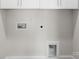 A wall with hookups ready for laundry, with painted cabinets above at 1322 Condon St, Charlotte, NC 28216