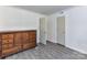 Bedroom featuring a wooden dresser, doors, and grey flooring at 1327 Santee St, Charlotte, NC 28208