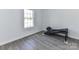 Bedroom with light gray wood flooring and a window providing natural light at 1327 Santee St, Charlotte, NC 28208