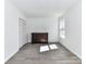 Bedroom featuring a window, closet doors, and grey flooring at 1327 Santee St, Charlotte, NC 28208