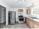 Bright kitchen featuring stainless steel appliances and wood cabinets at 1327 Santee St, Charlotte, NC 28208