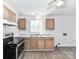 Functional kitchen featuring wood cabinets, modern appliances, and natural light creating a convenient space for cooking at 1327 Santee St, Charlotte, NC 28208